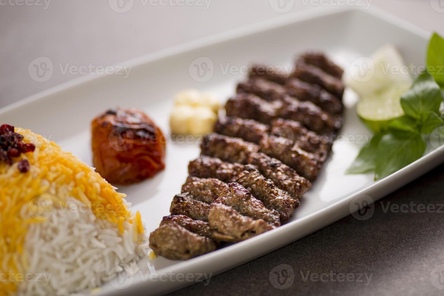 chelo kebab with biryani rice and salad served in dish isolated on grey background top view of arabic food photo