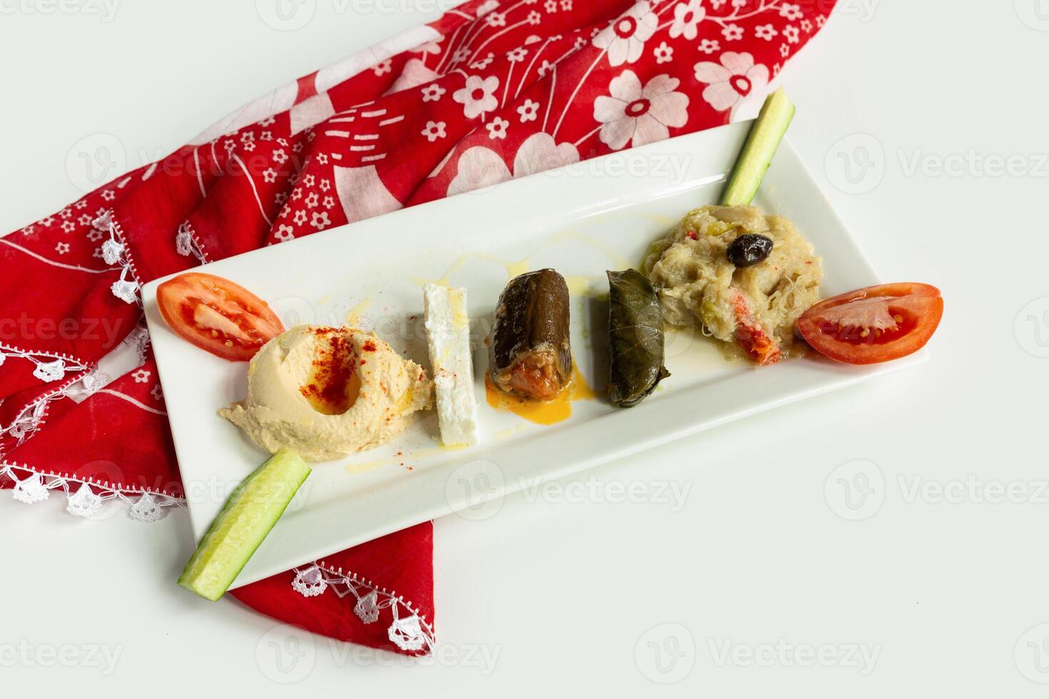traditional Turkish pastries ordov tabagi in a dish isolated on colorful table cloth top view on grey background photo