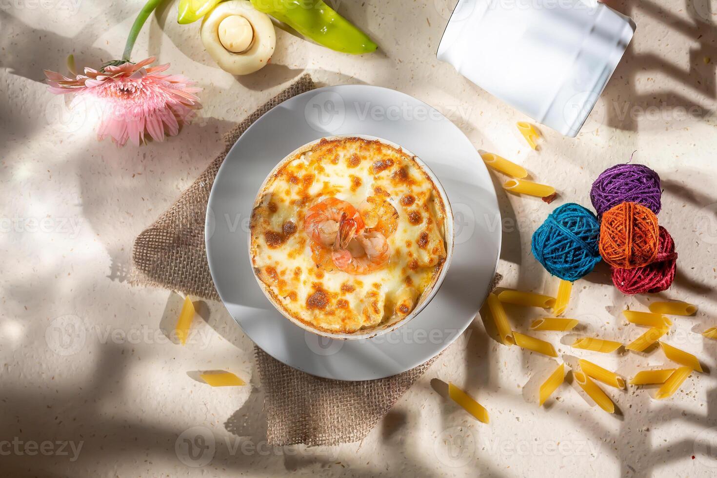 Seefood pasta with cream sauce and raw tomato in a bowl isolated on background side view photo