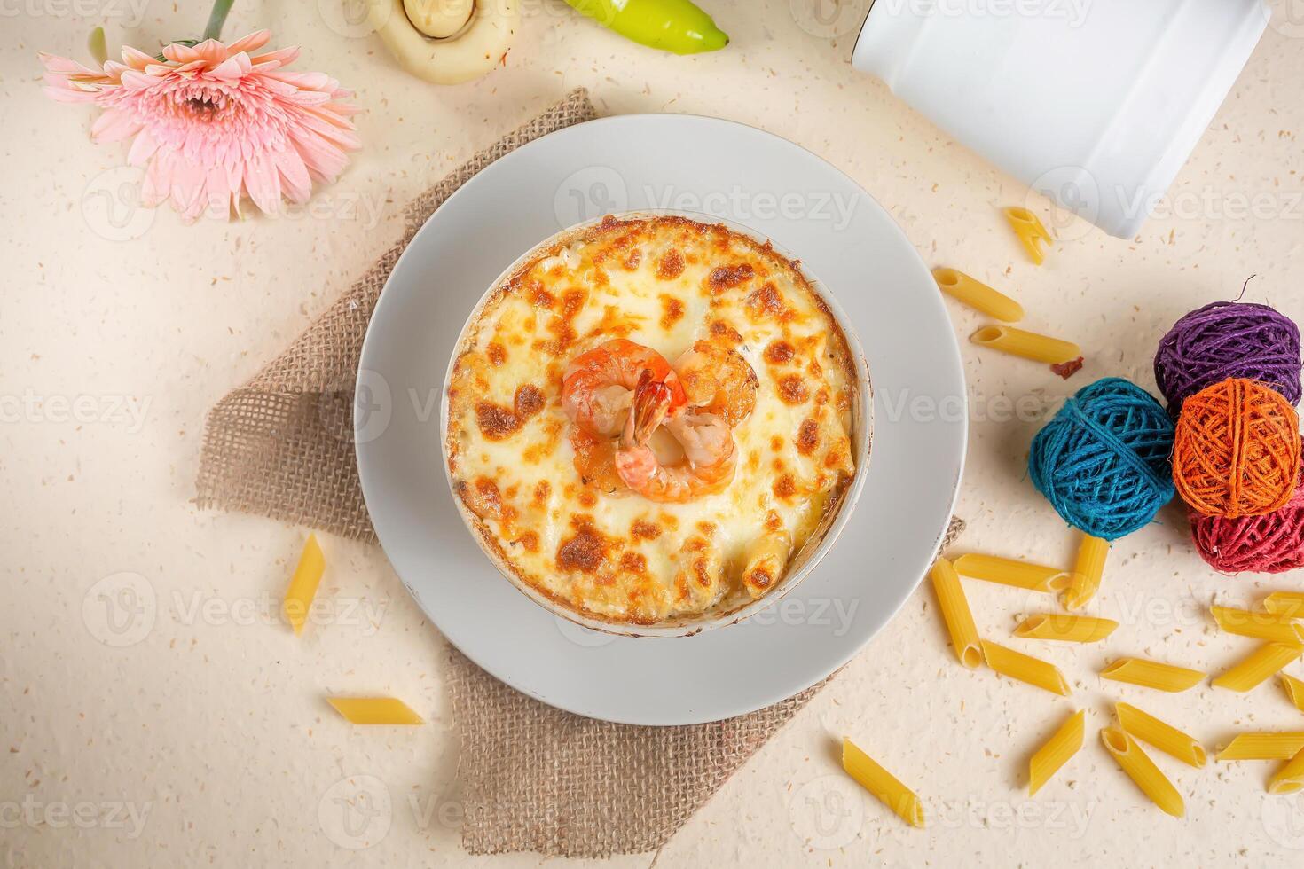 Seefood pasta with cream sauce and raw tomato in a bowl isolated on background side view photo