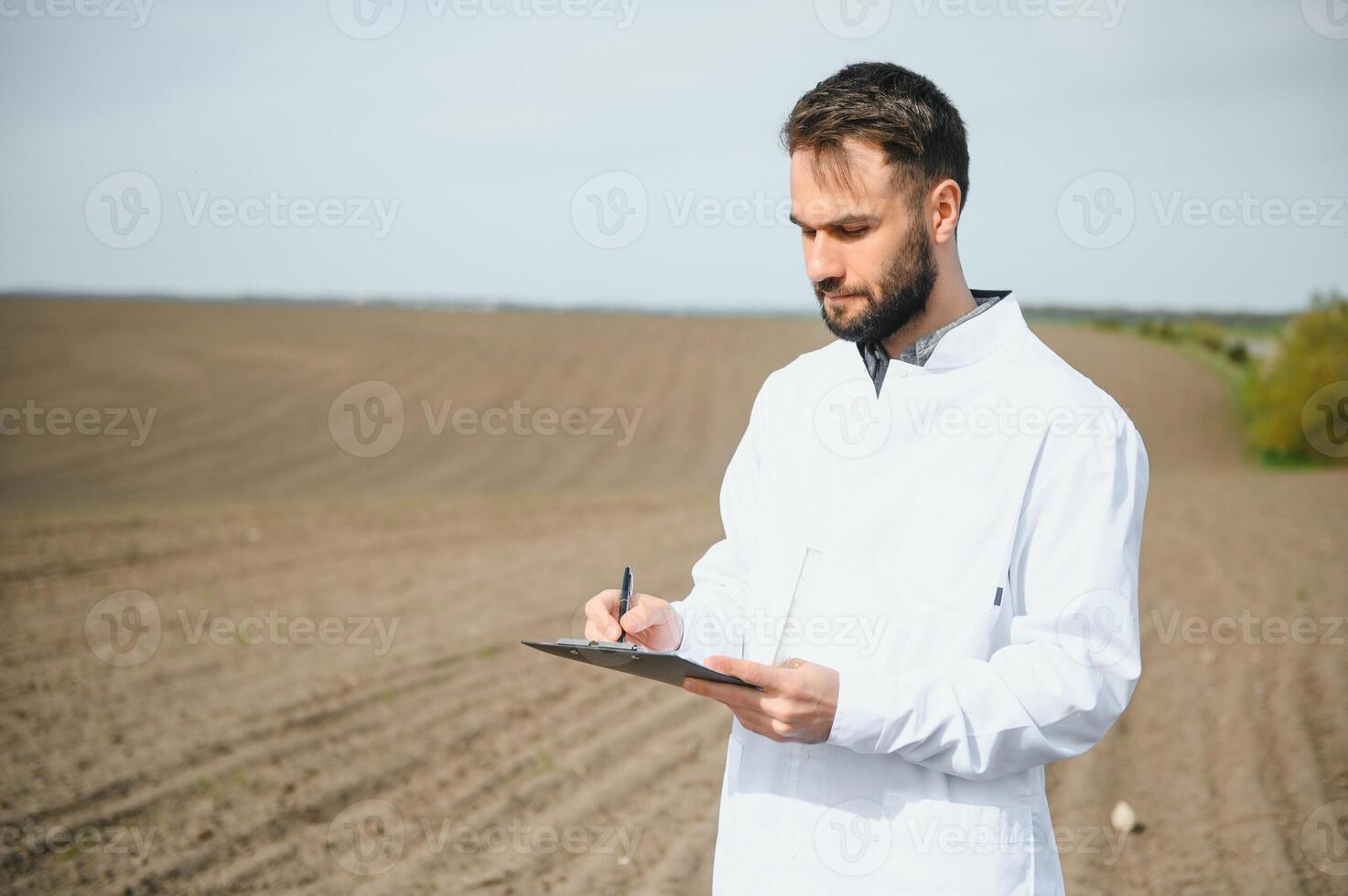 Soil Testing. Agronomy Specialist taking soil sample for fertility analysis. Hands in gloves close up. Environmental protection, organic soil certification, field work, research. photo