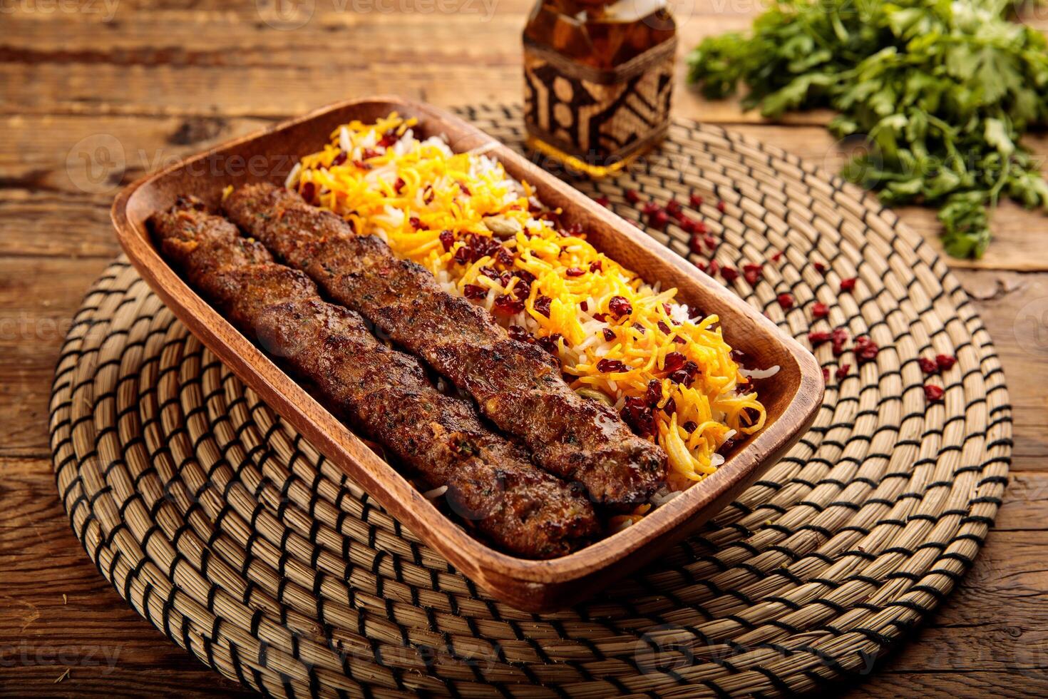 Chelo Kebab Kobideh served in a wooden cutting board isolated on wooden background side view photo