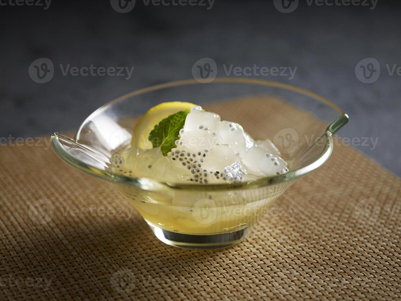 Chilled Aloe Vera in Lemonade served in a dish isolated on wooden board side view dark background photo