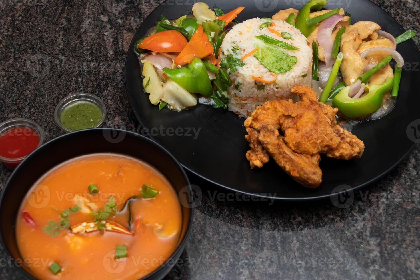 Chinese platter with fried ricem chicken fry, thai soup green chilli sauce and mixed vegetable served in dish isolated on background top view of bangladesh and indian food photo