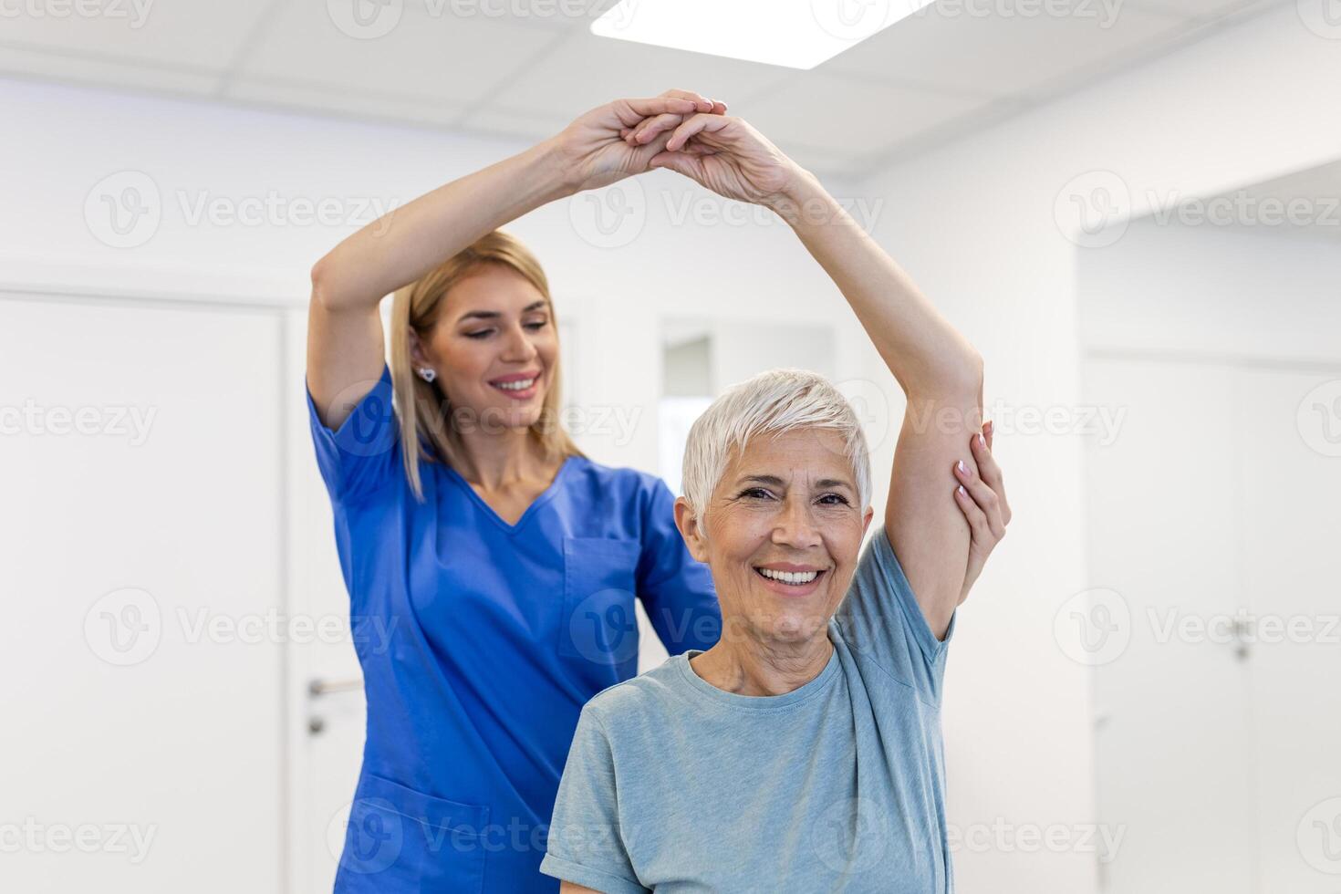 A Modern rehabilitation physiotherapy worker with senior client. Physiotherapist working with mature patient in rehabilitation center photo