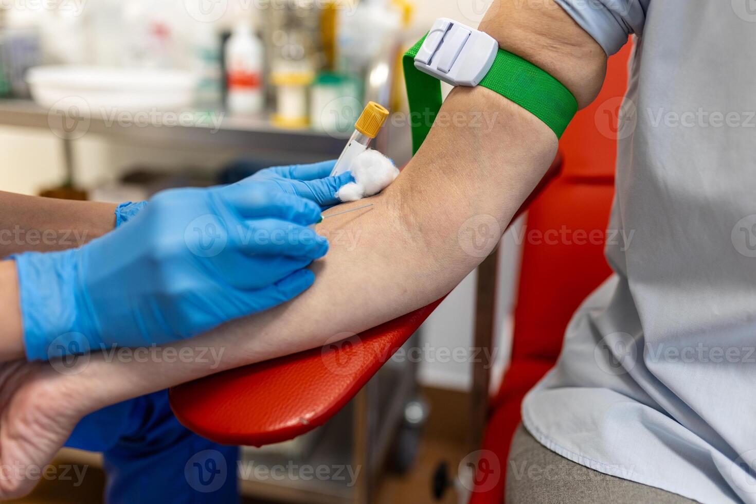 Preparation for blood test with senior woman by female doctor medical uniform on the table in white bright room. Nurse pierces the patient's arm vein with needle blank tube. photo