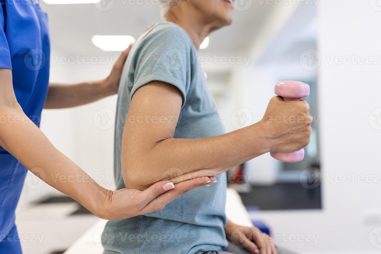 Professional Physiotherapist Working on Specific Muscle Groups and Back Pain with senior Female. Woman Recovering from Mild Injury. Trauma Prevention Therapy or Rehabilitation at Clinic photo