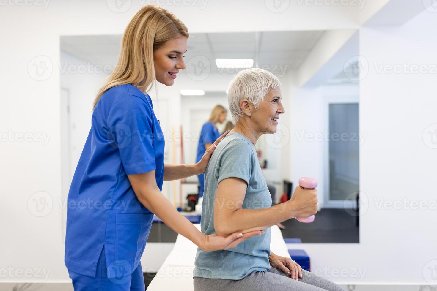 Professional Physiotherapist Working on Specific Muscle Groups and Back Pain with senior Female. Woman Recovering from Mild Injury. Trauma Prevention Therapy or Rehabilitation at Clinic photo