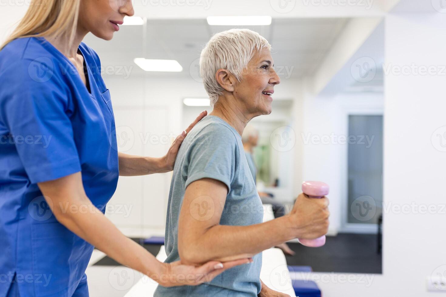Professional Physiotherapist Working on Specific Muscle Groups and Back Pain with senior Female. Woman Recovering from Mild Injury. Trauma Prevention Therapy or Rehabilitation at Clinic photo