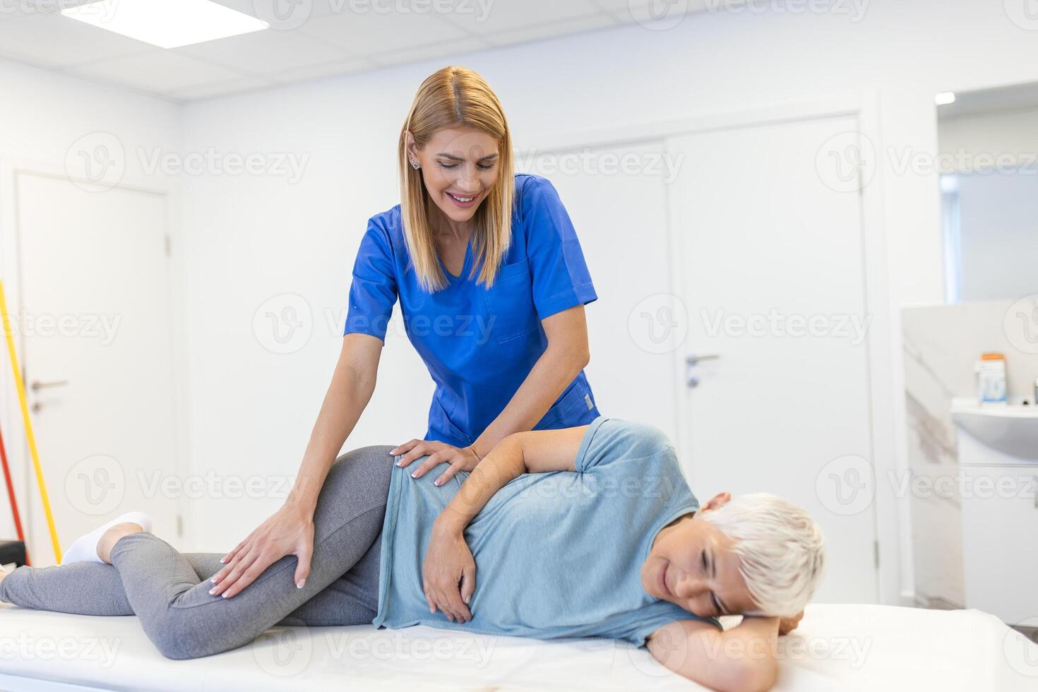 Senior Patient Undergoing Physical Therapy in Clinic to Recover from Surgery and Increase Mobility. Physiotherapist Works on Specific Muscle Groups or Joints to Rehabilitate from Injury. photo