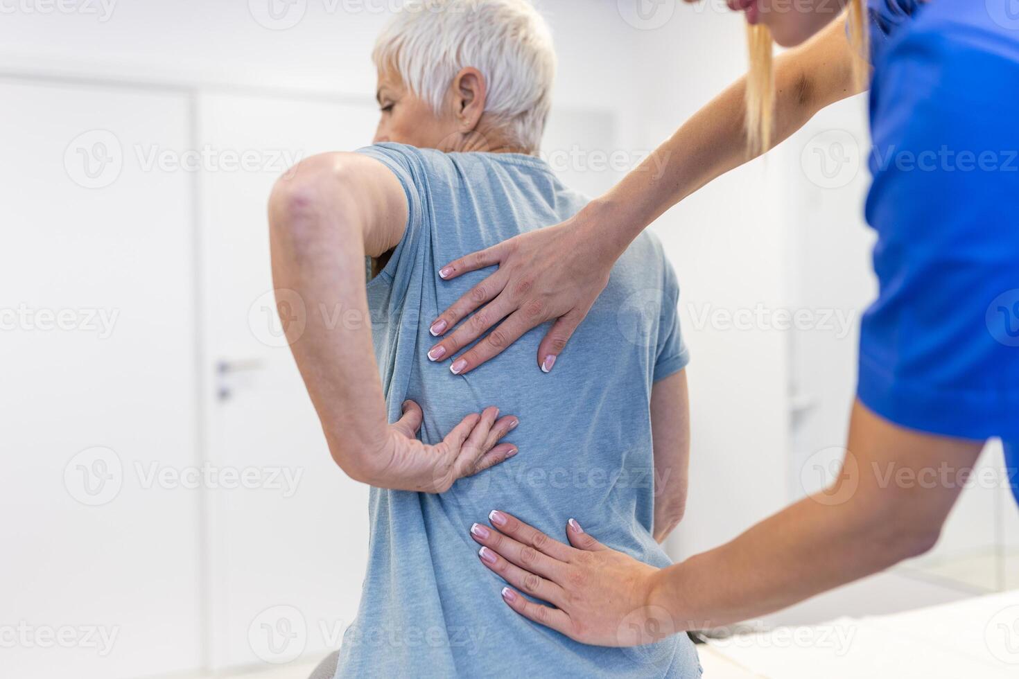 Senior woman having chiropractic back adjustment. Osteopathy, Alternative medicine, pain relief concept. Physiotherapy, injury rehabilitation photo