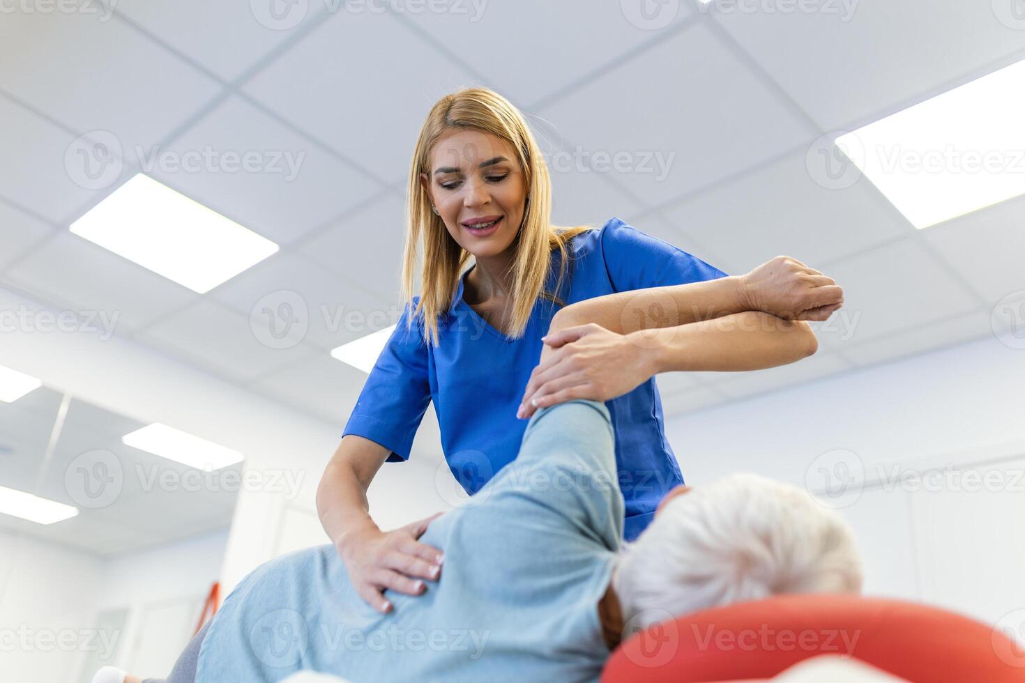 Senior woman having chiropractic back adjustment. Osteopathy, Alternative medicine, pain relief concept. Physiotherapy, injury rehabilitation photo