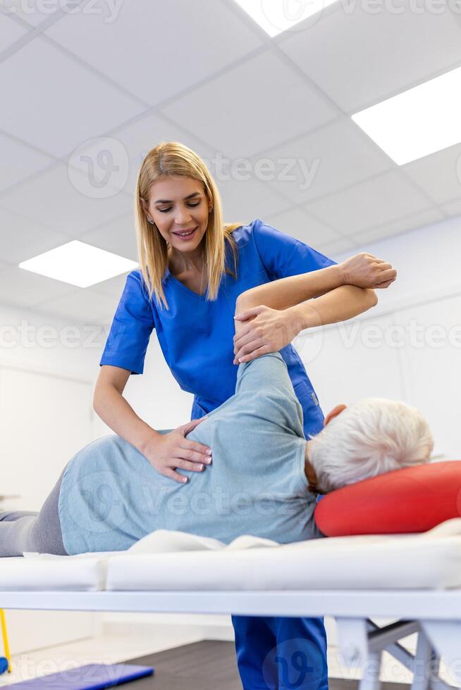 Senior Patient Undergoing Physical Therapy in Clinic to Recover from Surgery and Increase Mobility. Physiotherapist Works on Specific Muscle Groups or Joints to Rehabilitate from Injury. photo