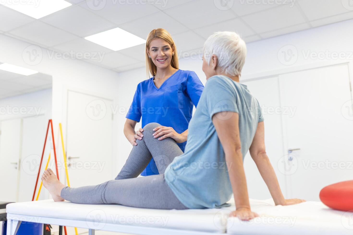 physiotherapist massaging and kneading a patient's leg provides medical care for sprained ligaments. Concept of rehabilitation and recovery after physical leg injuries. photo