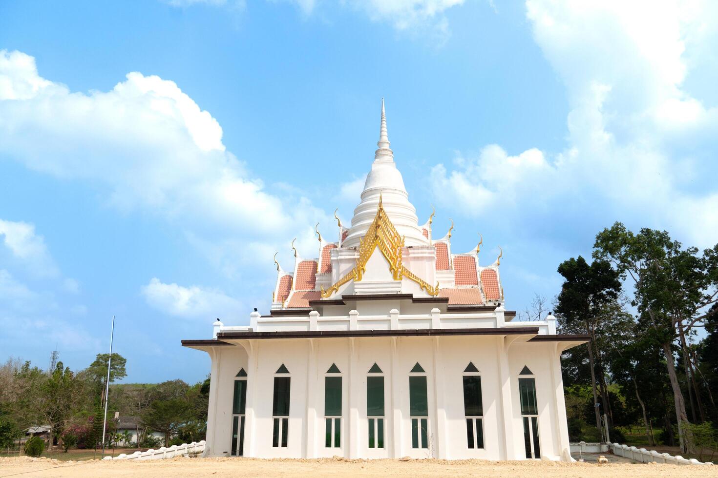 White pagoda in thai temple with blue sky and cloud background. At Wat Tham Khao Bot Tample Wangchan Rayong Thailand. photo