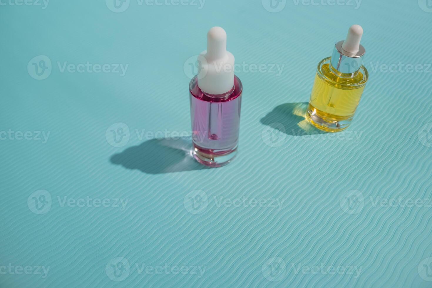 Face oil glass bottles on blue background photo
