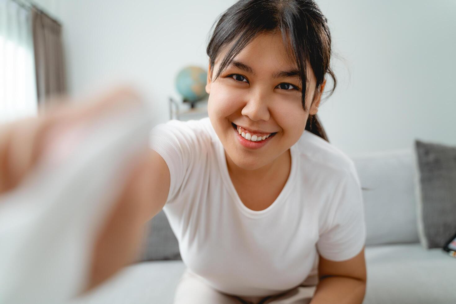 A woman is wiping cleaning the camera lens or screen monitor with paper towel photo