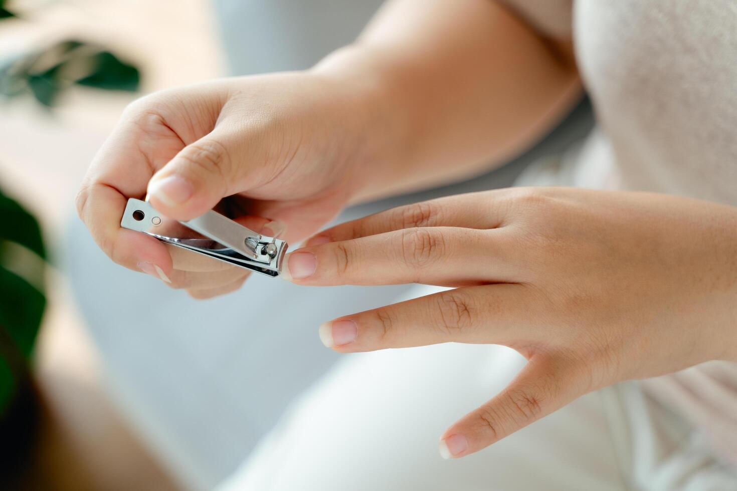 A woman is holding a pair of nail clippers photo