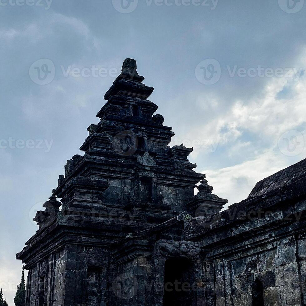 Dramatic and dynamic Sunrise at Arjuna Temple of Dieng-Central Java photo