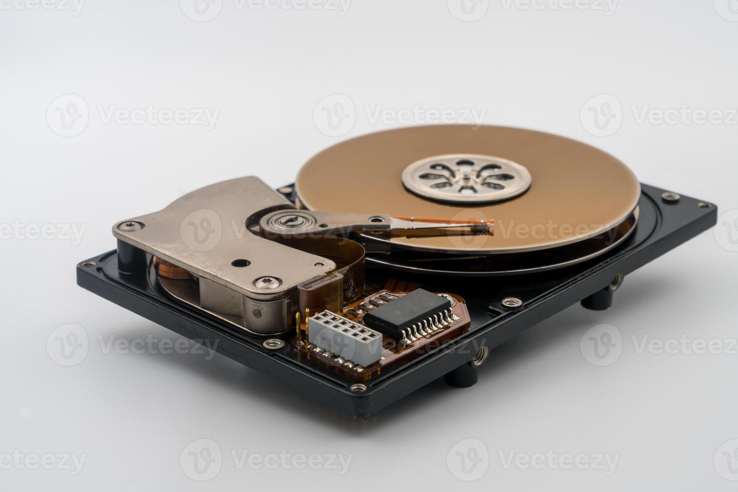 HDD, Hard disk drive, platters, circular magnetic disk. Mechanical and electronic components. Actuator arm with read write head. Central spindle. Circuit board. Precision device for data storage. photo