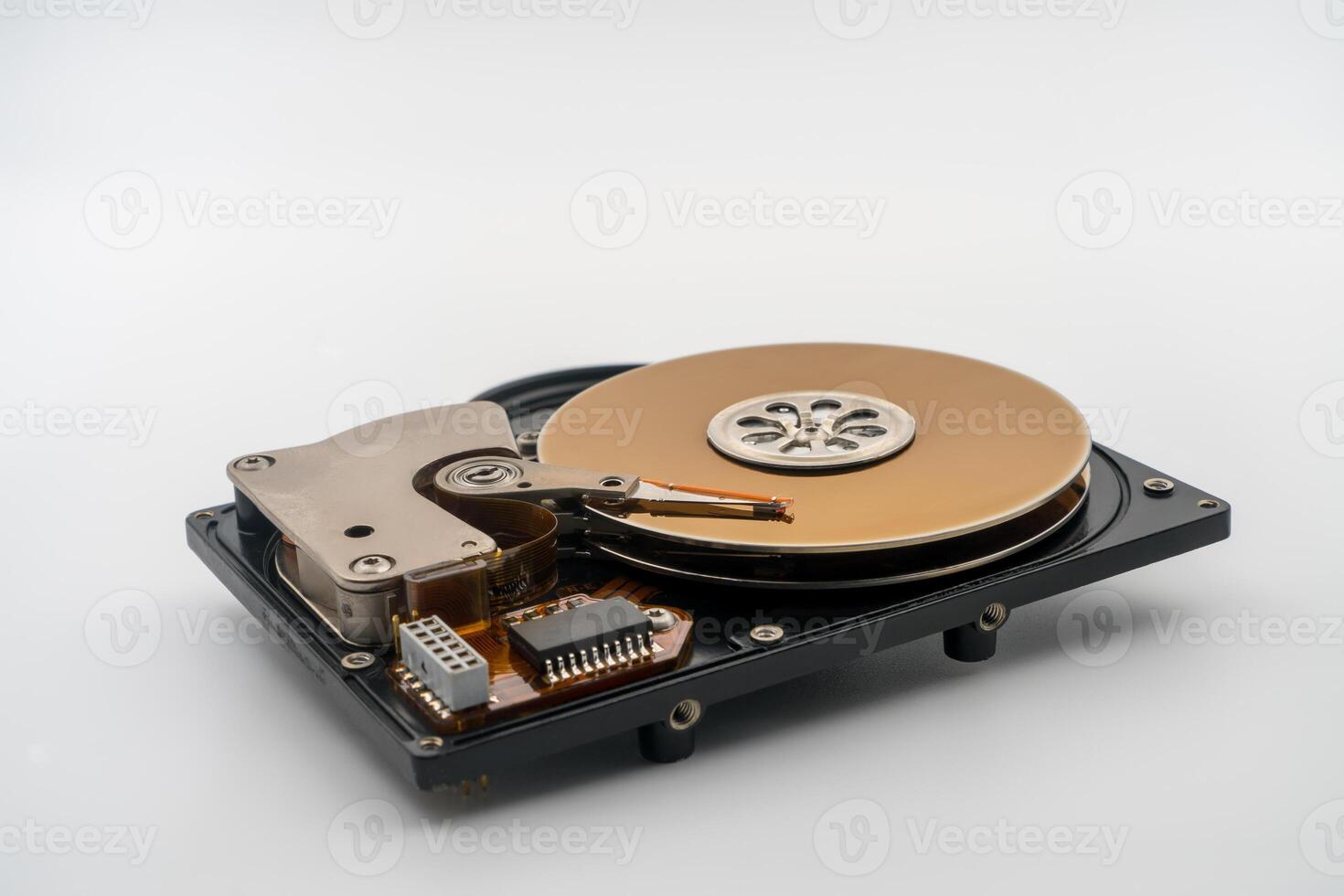 HDD, Hard disk drive, platters, circular magnetic disk. Actuator arm with read write head. Central spindle. Circuit board. Mechanical and electronic components. Precision device for data storage. photo