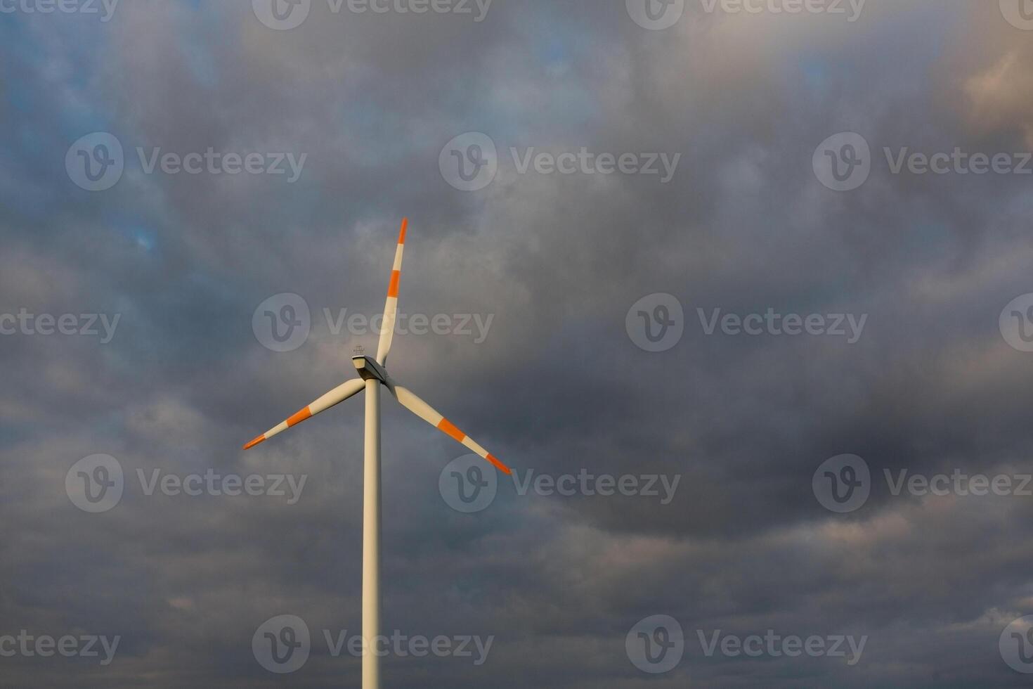 Wind turbine on the background of the blue sky. Clean renewable energy. Electric power production. photo
