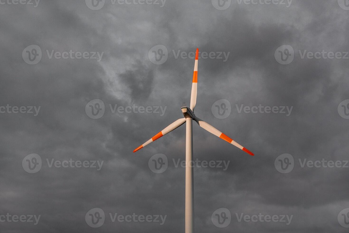 Wind turbine on the background of the blue sky. Clean renewable energy. Electric power production. photo