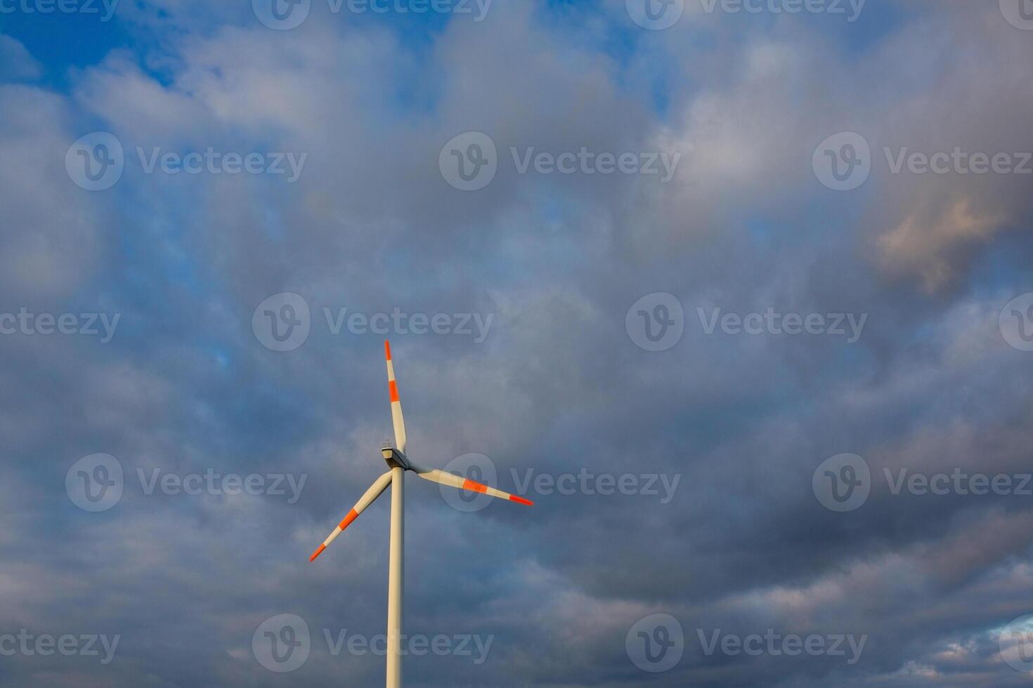 Wind turbine on the background of the blue sky. Clean renewable energy. Electric power production. photo