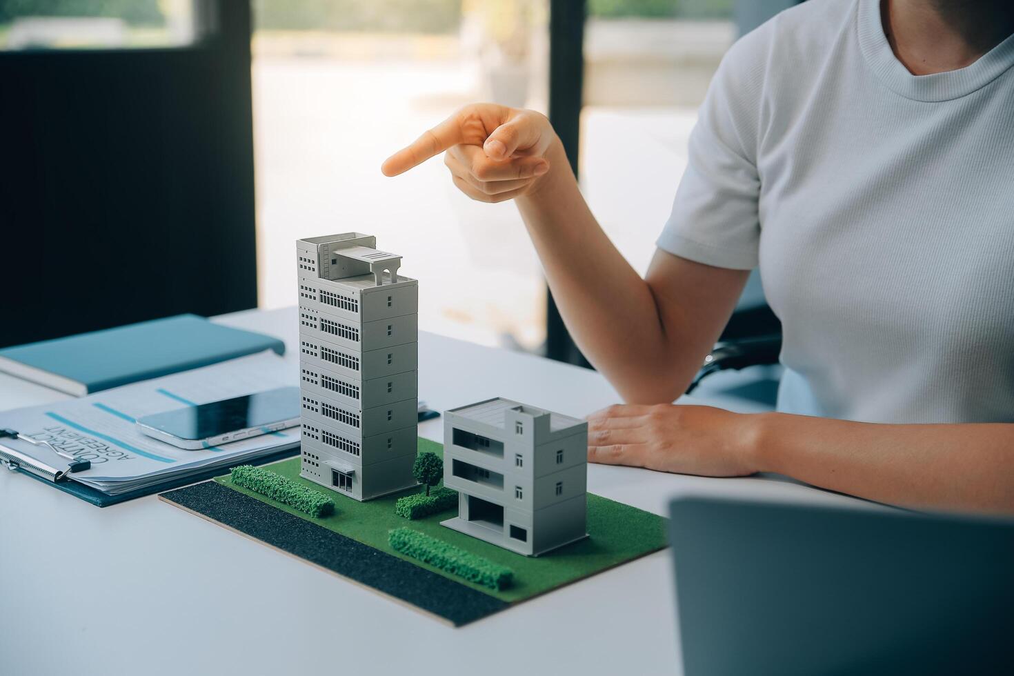 Real estate broker agent presenting and consult to customer to decision making sign insurance form agreement, buy and sell home model, concerning mortgage loan offer for and house insurance photo