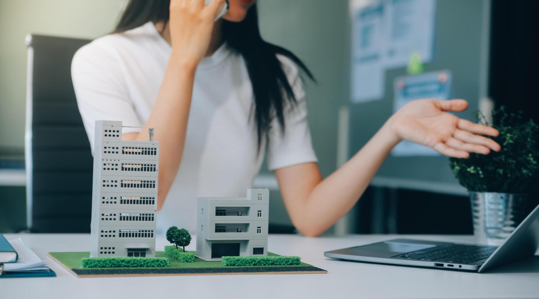 Real estate broker agent presenting and consult to customer to decision making sign insurance form agreement, buy and sell home model, concerning mortgage loan offer for and house insurance photo