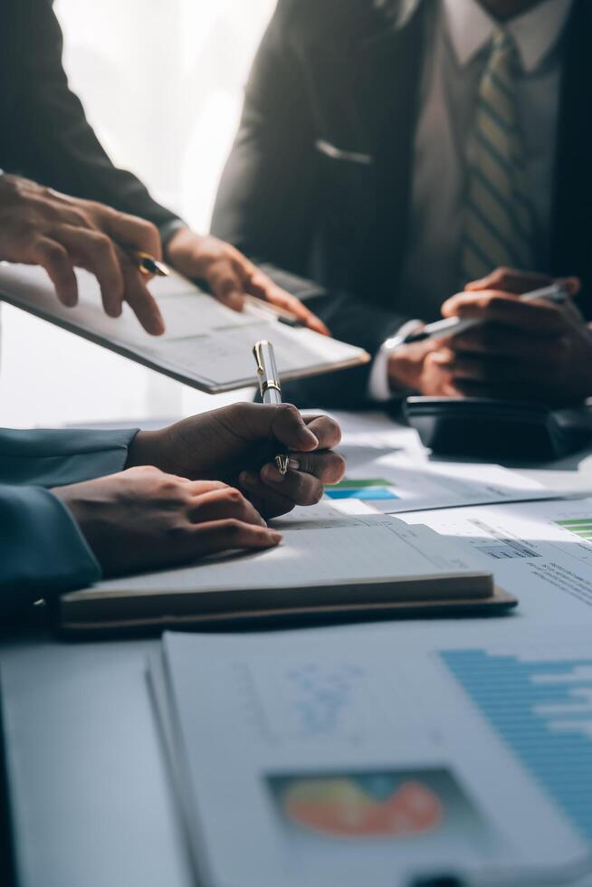 Business team meeting present, investor colleagues consultation and conference new strategy plan business and market growth on financial document graph report, Meeting and Talking. photo