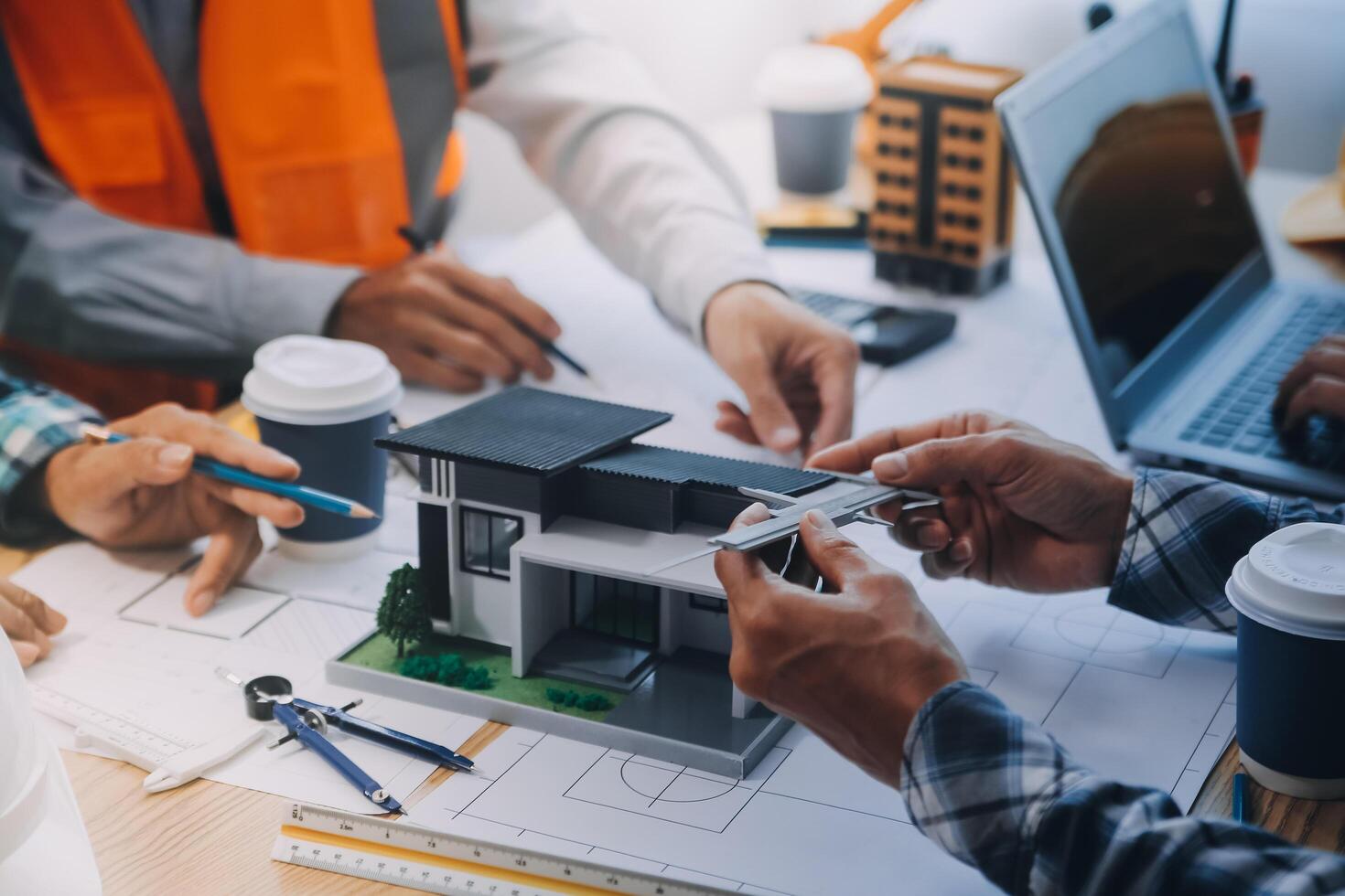 Image of engineer meeting for architectural project. working with partner and engineering tools on workplace vintage tone. photo