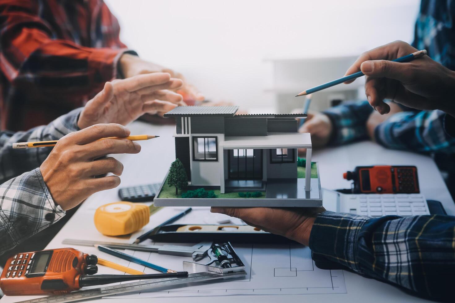 engineer people meeting working and pointing at a drawings in office for discussing. Engineering tools and construction concept. photo