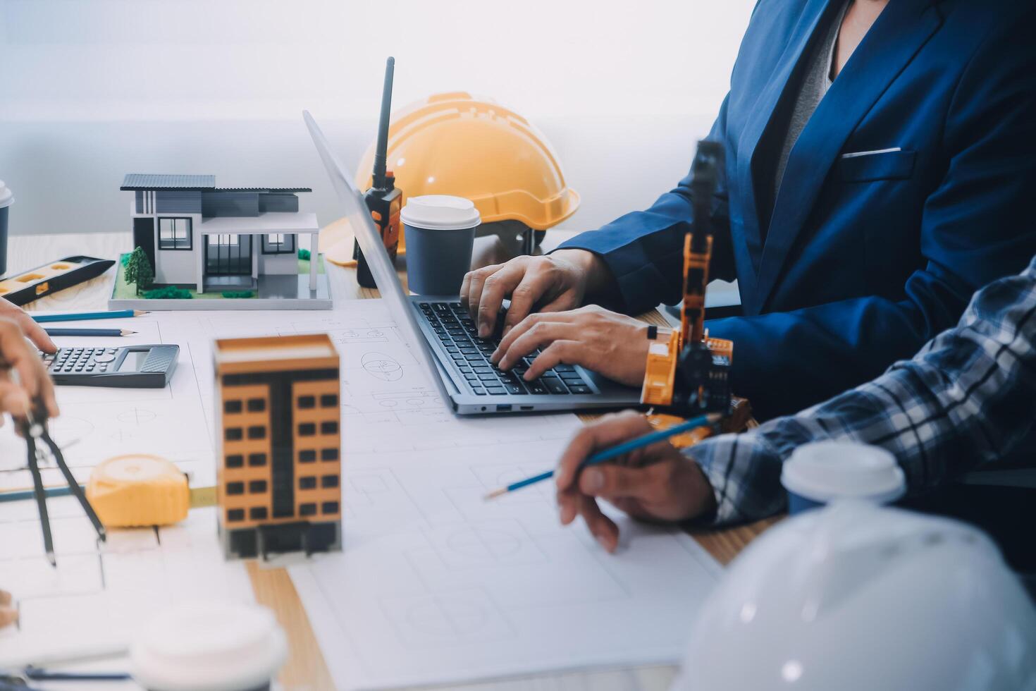 Image of engineer meeting for architectural project. working with partner and engineering tools on workplace vintage tone. photo