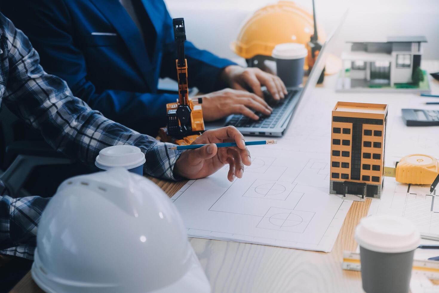 Image of engineer meeting for architectural project. working with partner and engineering tools on workplace vintage tone. photo