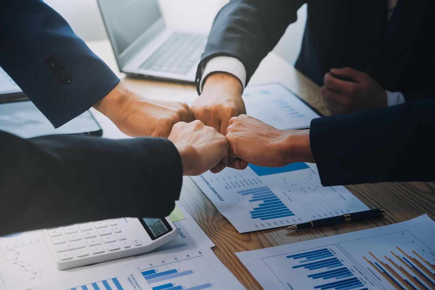 Business people join hands to join forces as a teamwork. photo