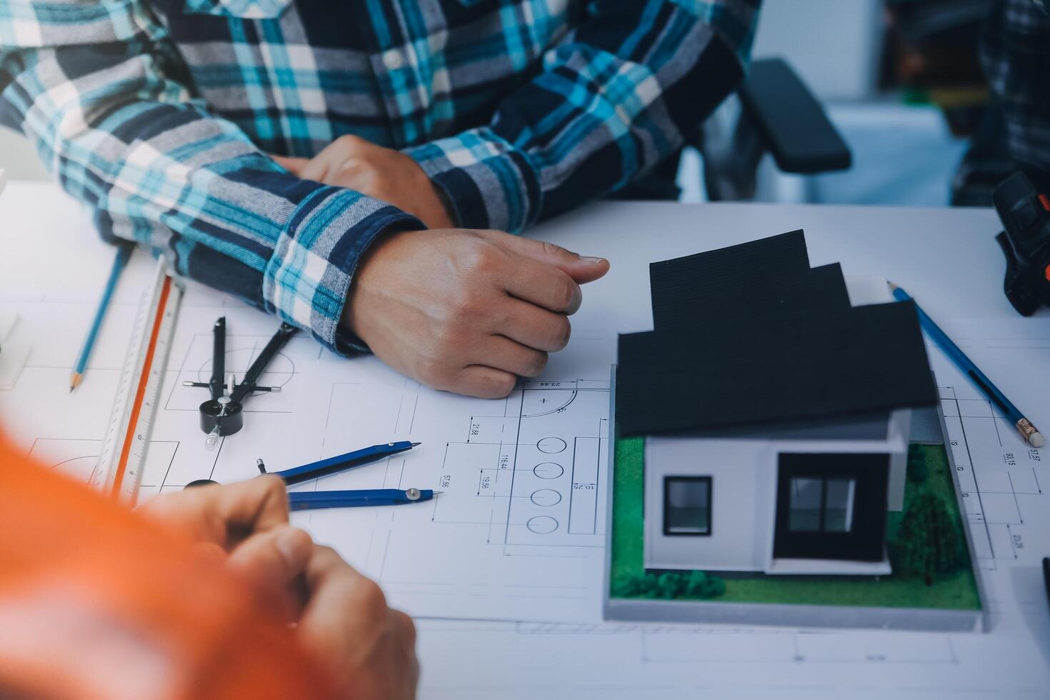engineer people meeting working and pointing at a drawings in office for discussing. Engineering tools and construction concept. photo