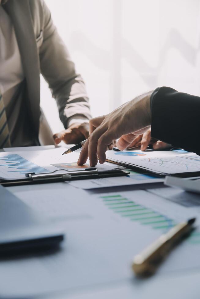 Business team meeting present, investor colleagues consultation and conference new strategy plan business and market growth on financial document graph report, Meeting and Talking. photo