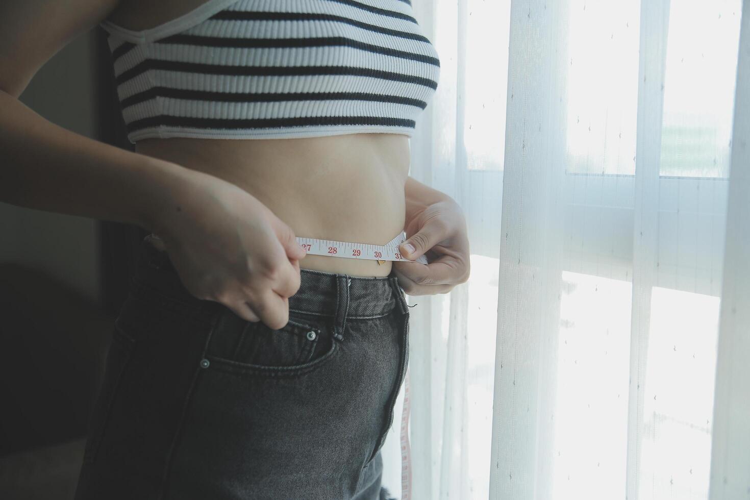 Women body fat belly. Obese woman hand holding excessive belly fat. diet lifestyle concept to reduce belly and shape up healthy stomach muscle. photo