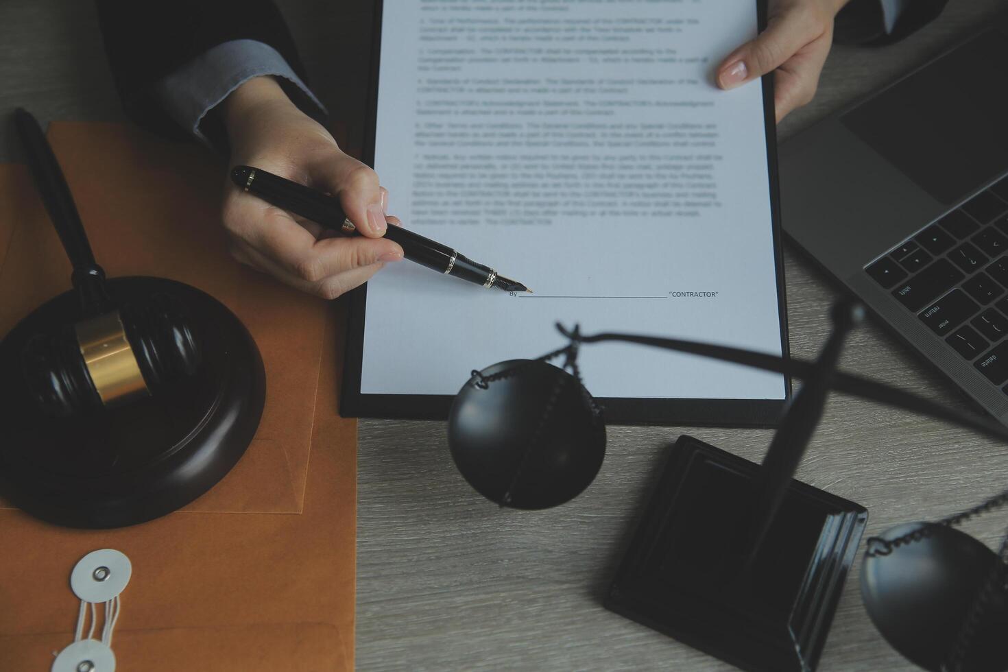 Business and lawyers discussing contract papers with brass scale on desk in office. Law, legal services, advice, justice and law concept picture with film grain effect photo