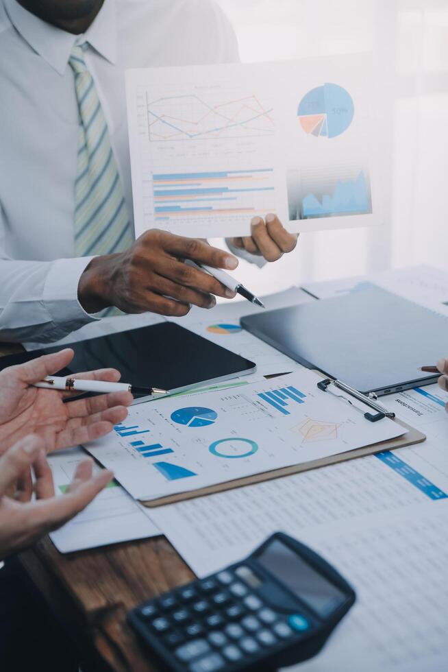Business team working with new startup project plan and discussion information for financial strategy with laptop and digital tablet in a modern business lounge. photo