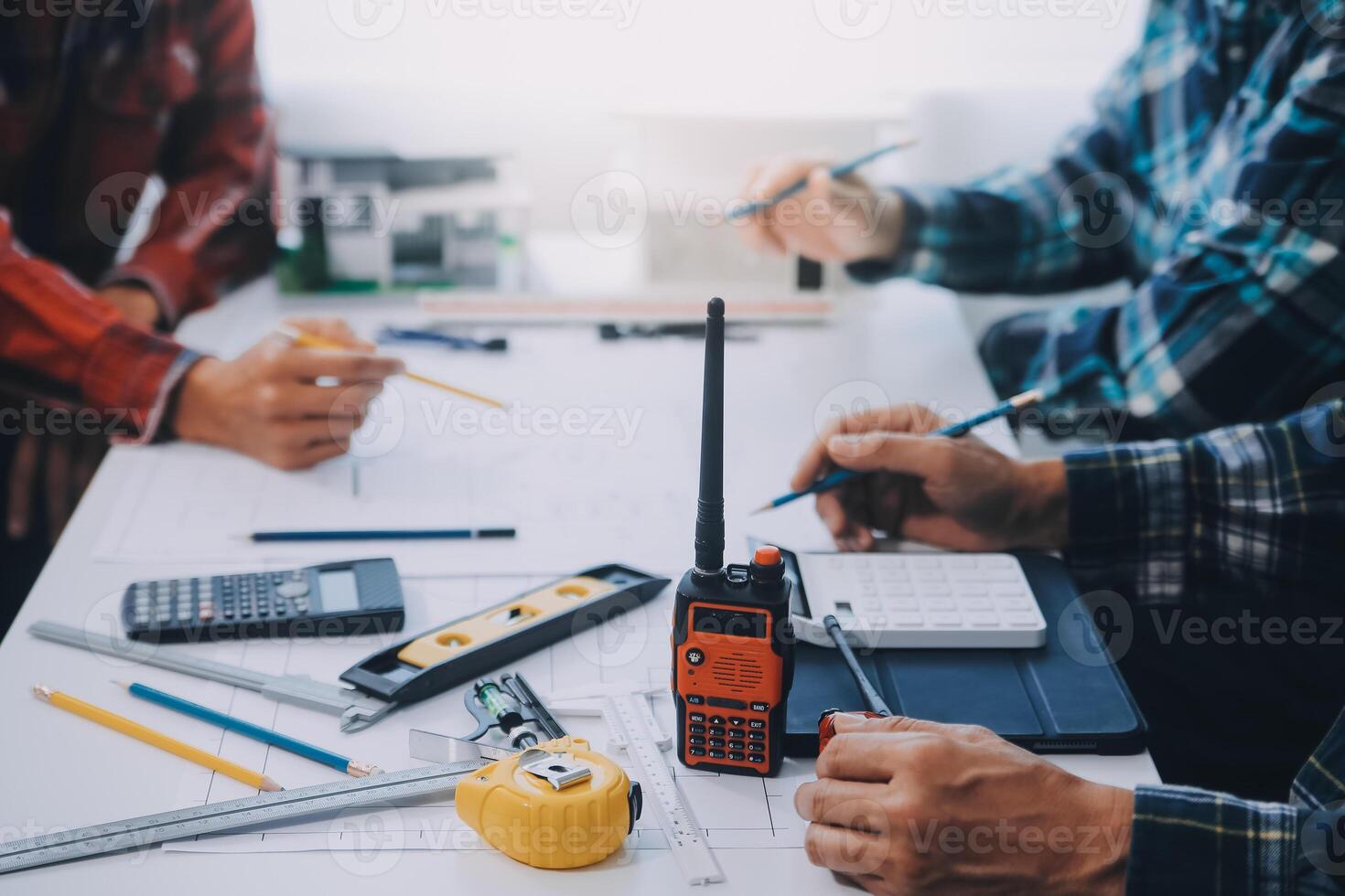 engineer people meeting working and pointing at a drawings in office for discussing. Engineering tools and construction concept. photo