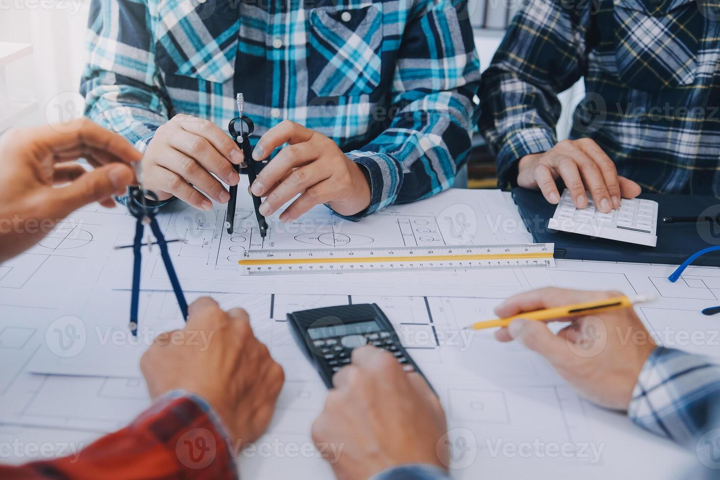 engineer people meeting working and pointing at a drawings in office for discussing. Engineering tools and construction concept. photo