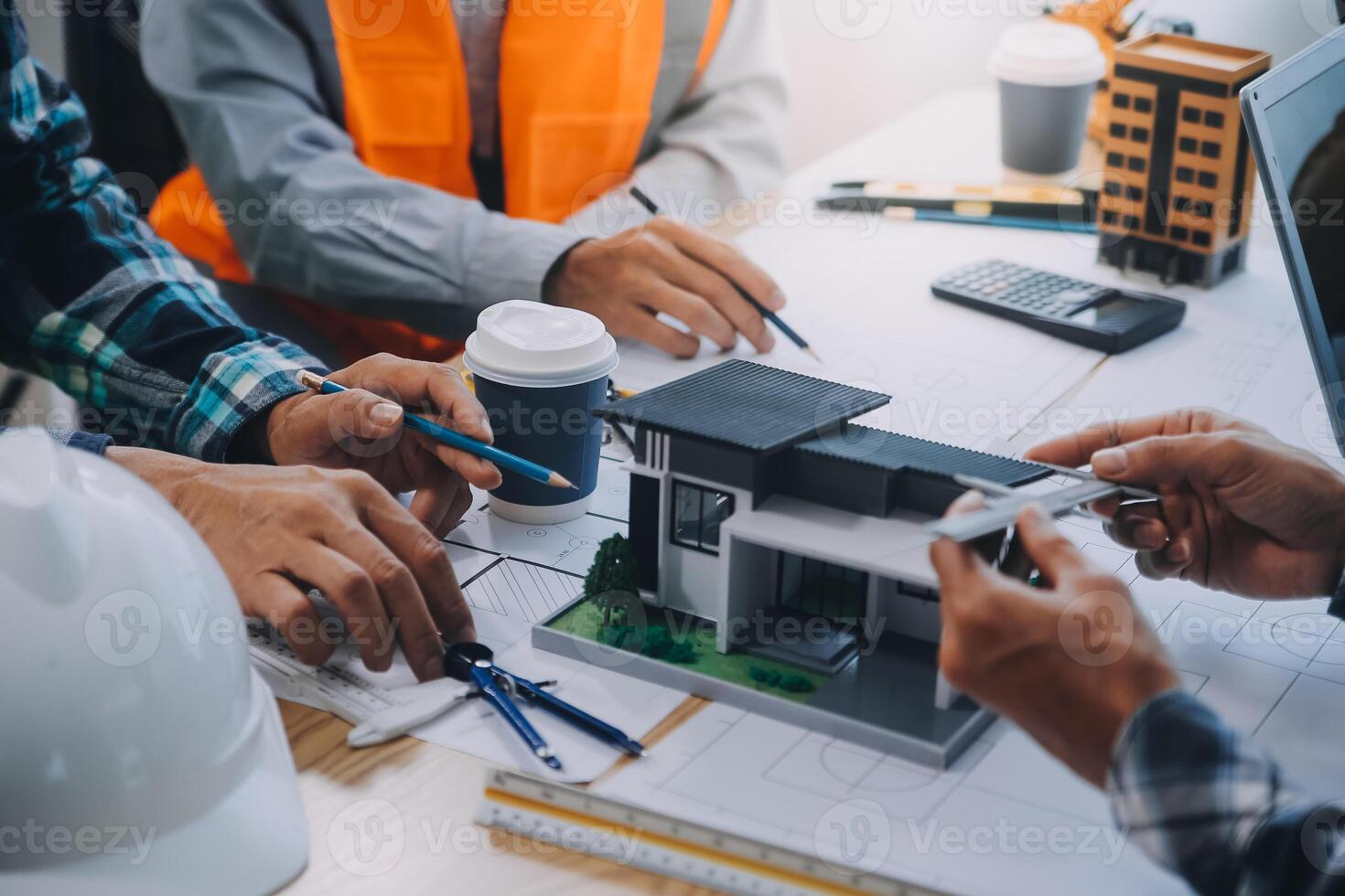 Image of engineer meeting for architectural project. working with partner and engineering tools on workplace vintage tone. photo