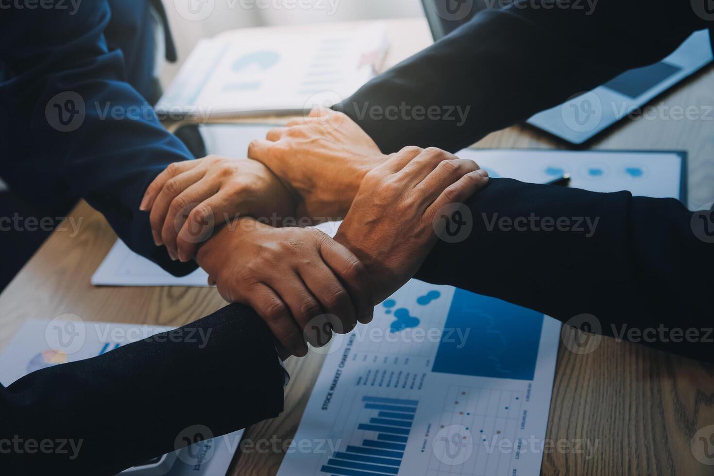 Business people join hands to join forces as a teamwork. photo
