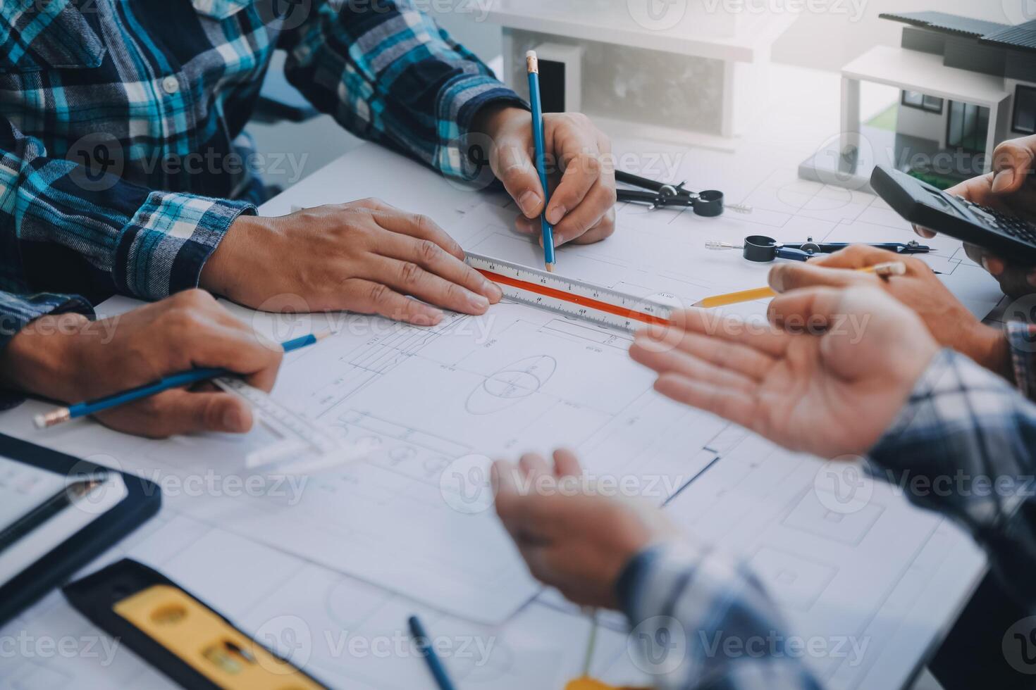 engineer people meeting working and pointing at a drawings in office for discussing. Engineering tools and construction concept. photo