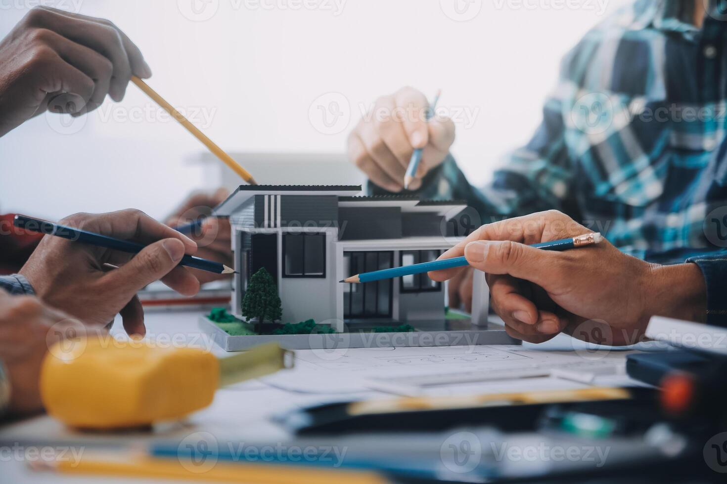 engineer people meeting working and pointing at a drawings in office for discussing. Engineering tools and construction concept. photo