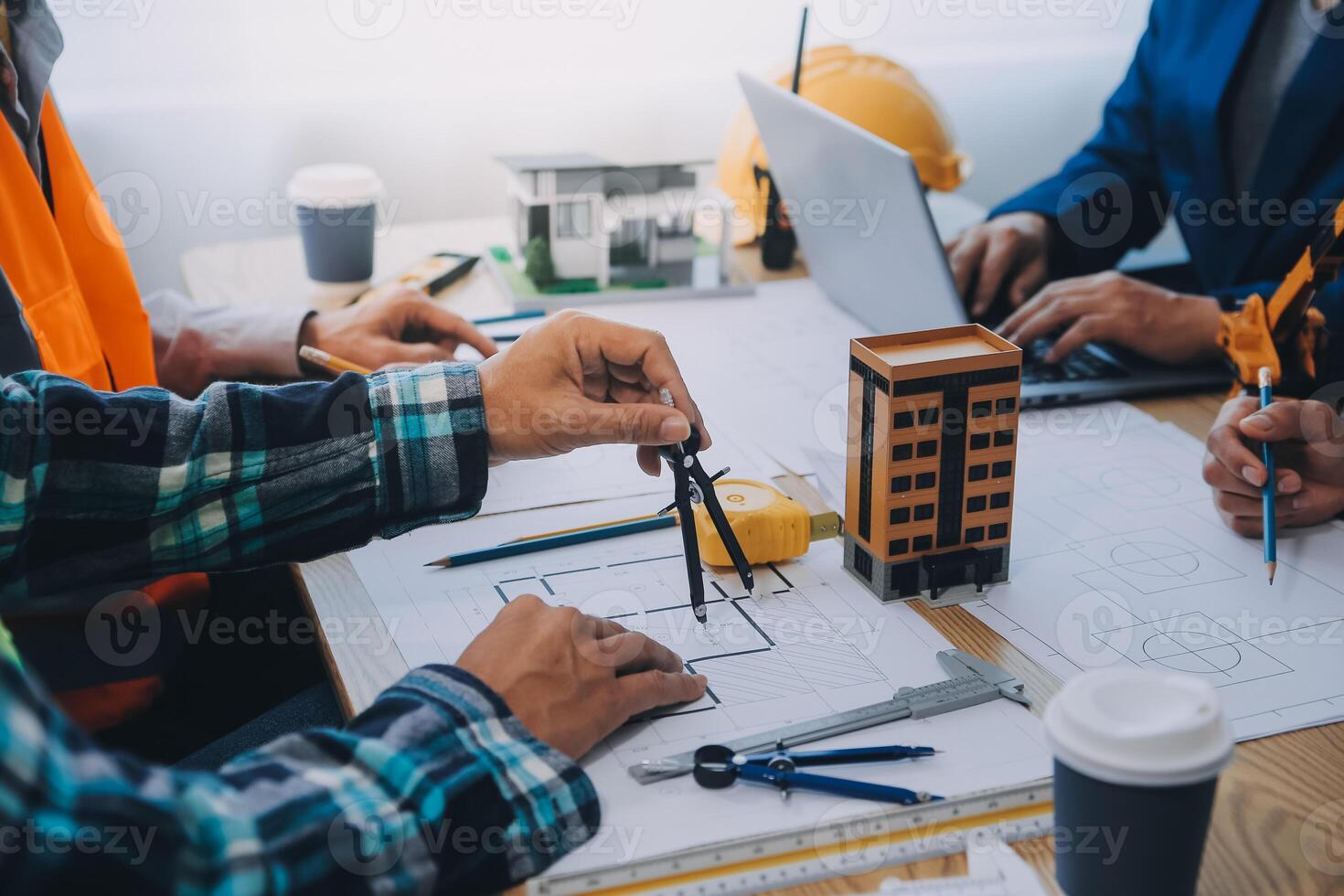 Image of engineer meeting for architectural project. working with partner and engineering tools on workplace vintage tone. photo