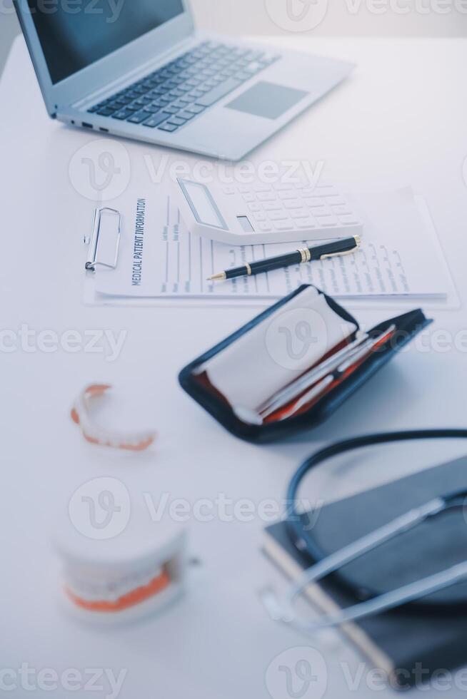 Denture and dental tools,dental mirror on white background photo