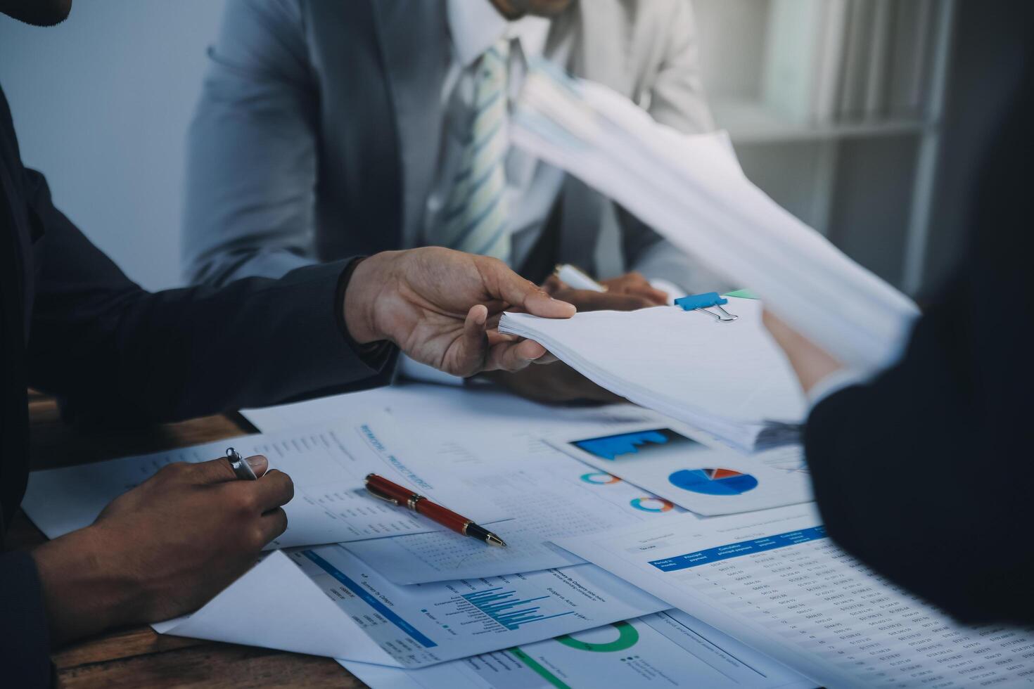 Business idea. Business people talking And calculations about charts and graphs showing the growth of investment results Of successful teamwork photo